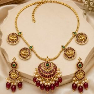 Mayurika South Indian peacock necklace set with ruby-red stones, green accents and matching earrings