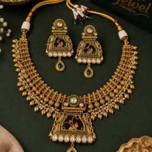 Rajnandini antique gold Rajwada necklace set with green accents, white stones and matching earrings