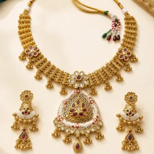 Rajshree Heritage Necklace Set flat lay with ruby-red stones, statement pendant and matching earrings