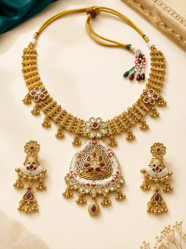 Rajshree Heritage Necklace Set flat lay with ruby-red stones, statement pendant and matching earrings