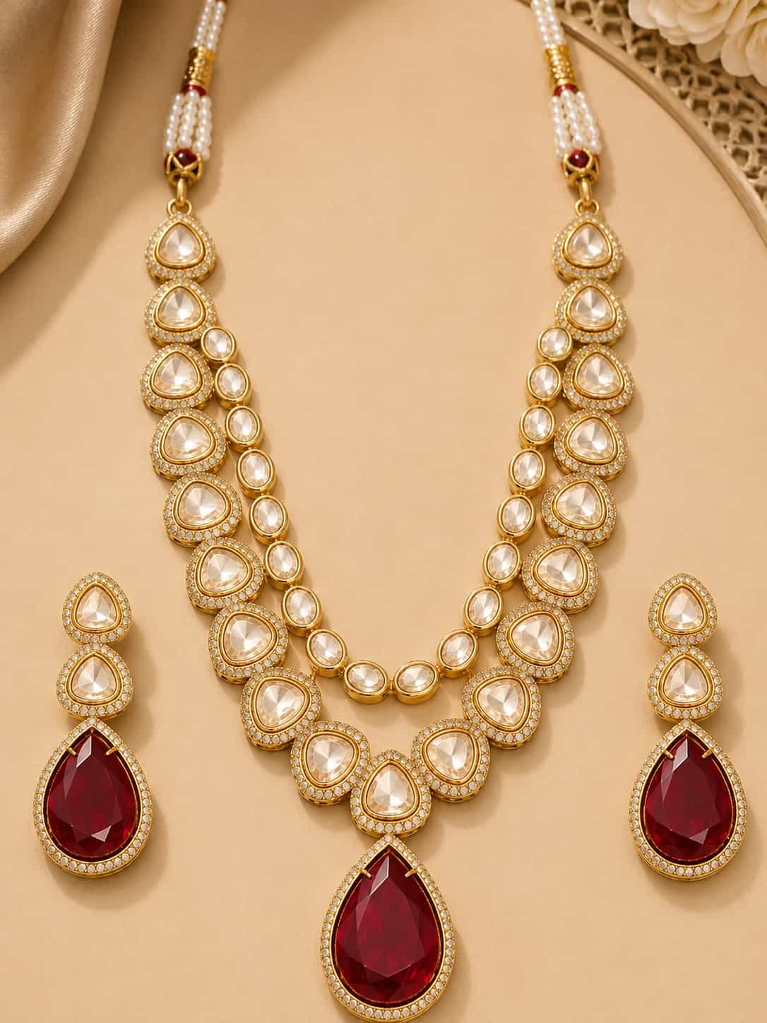 Full Rajeshwari gold-tone necklace set with white stones, ruby-red pendant and matching earrings