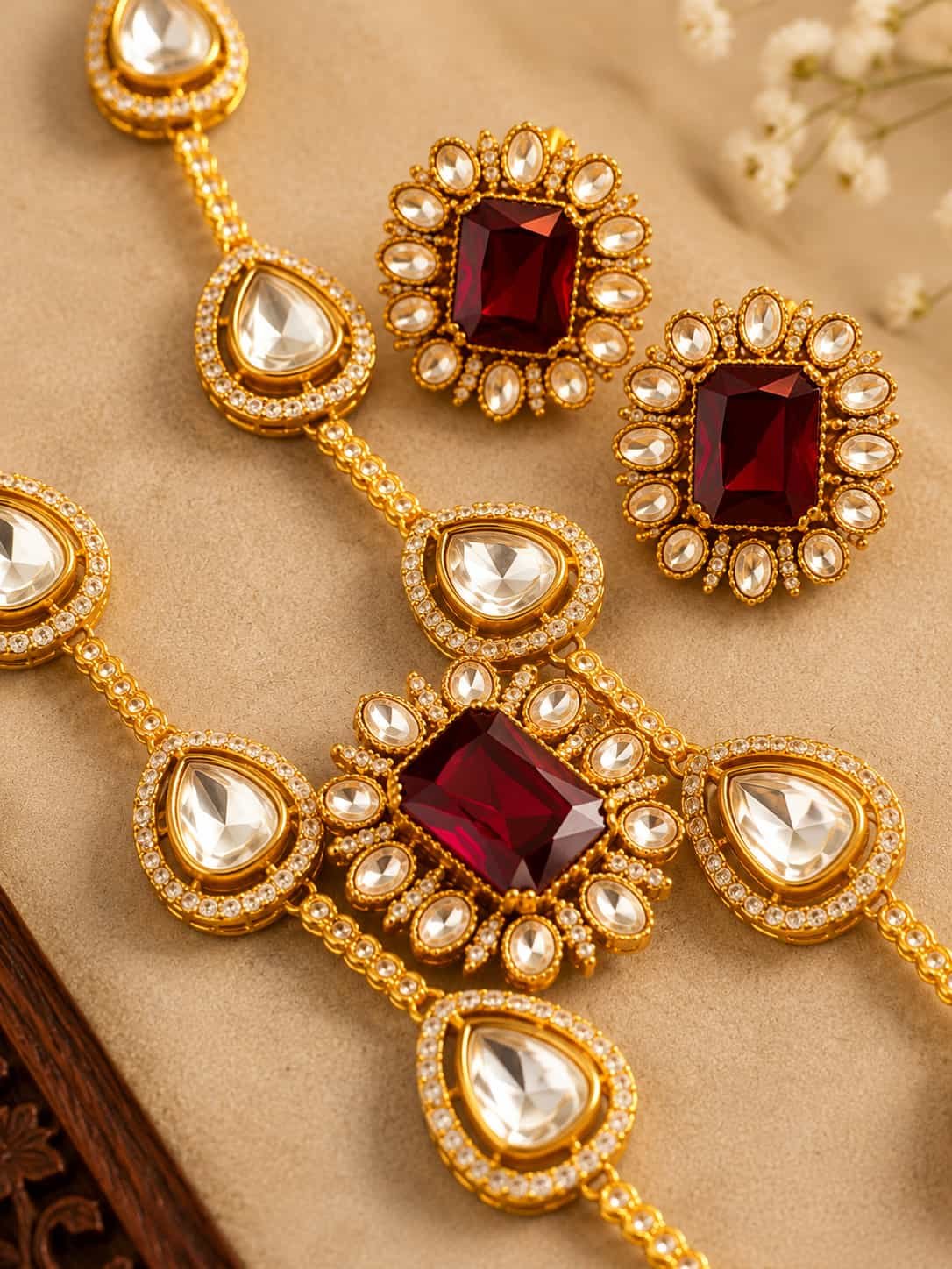 Close-up of ruby red and white stone Kundan Polki necklace and earrings